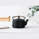 Lifestyle φωτογραφία της μαντεμένιας τσαγιέρας Flora σε στρωμένο τραπέζι.