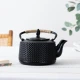 Lifestyle φωτογραφία της μαντεμένιας τσαγιέρας Flora σε στρωμένο τραπέζι, κοντινή λήψη.